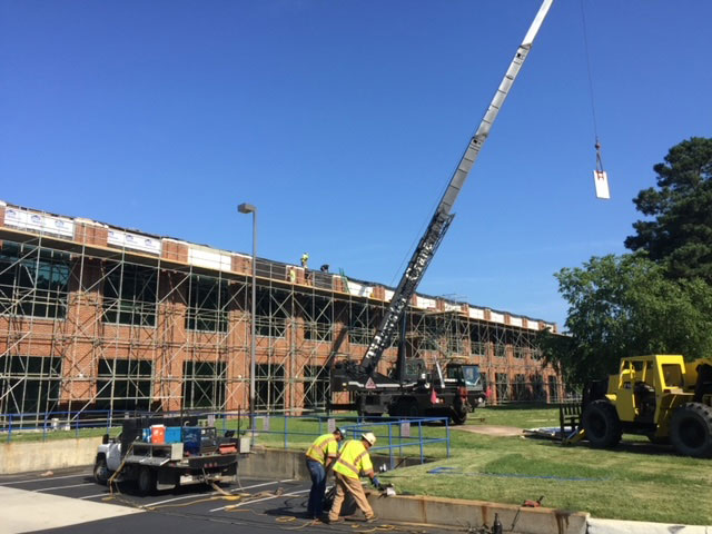 croy contracting inc. workers on commercial construction job at cox cable working on exterior