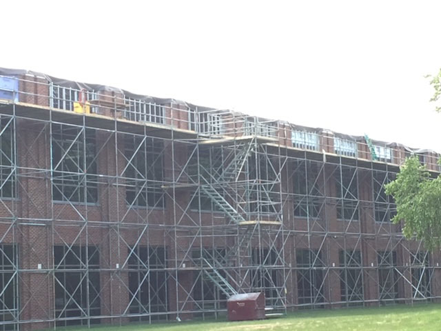 croy contracting inc. workers on commercial construction job at cox cable working on exterior