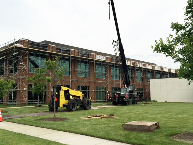 croy contracting inc. workers on commercial construction job at cox cable working on exterior