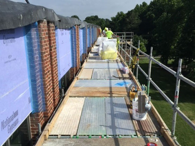 virginia-based croy contracting inc. working on commercial construction job at cox cable workers on scaffolding doing exterior work