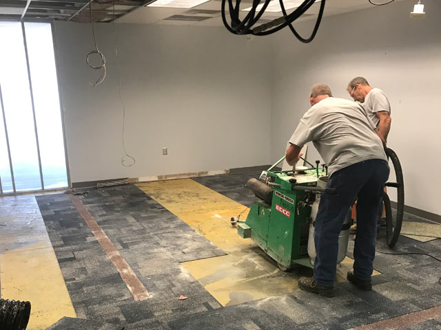 workers perform trench work at cox communications building for electrical work