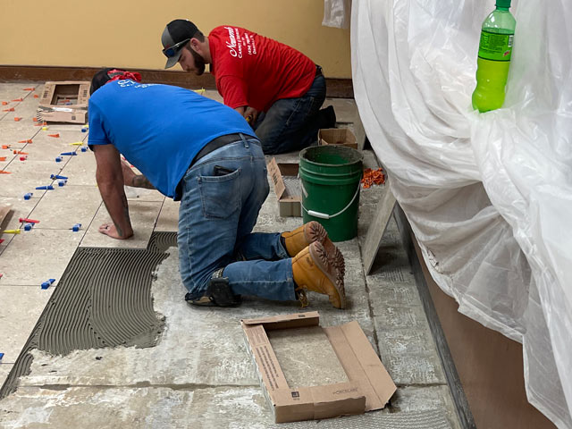 installing new tile during wells fargo interior remodel by croy contracting